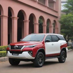 A vibrant tri-colored Toyota Fortuner in shades of red, black, and white occupies the frame. A solitary figure, their attention captivated, gazes upon the magnificent SUV.