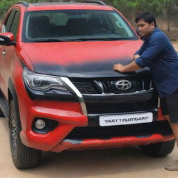 An impressive Fortuner car painted in shades of red, black, and white, with a person admirably looking at it.