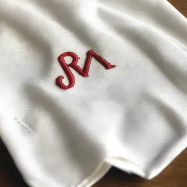 She lovingly stitched her partner's initials onto a handkerchief as a romantic gesture.