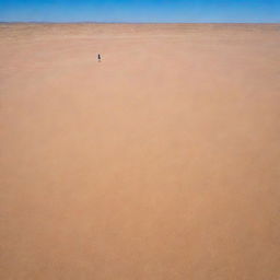 A girl standing alone in the vast expanse of a sandy desert under a bright blue sky