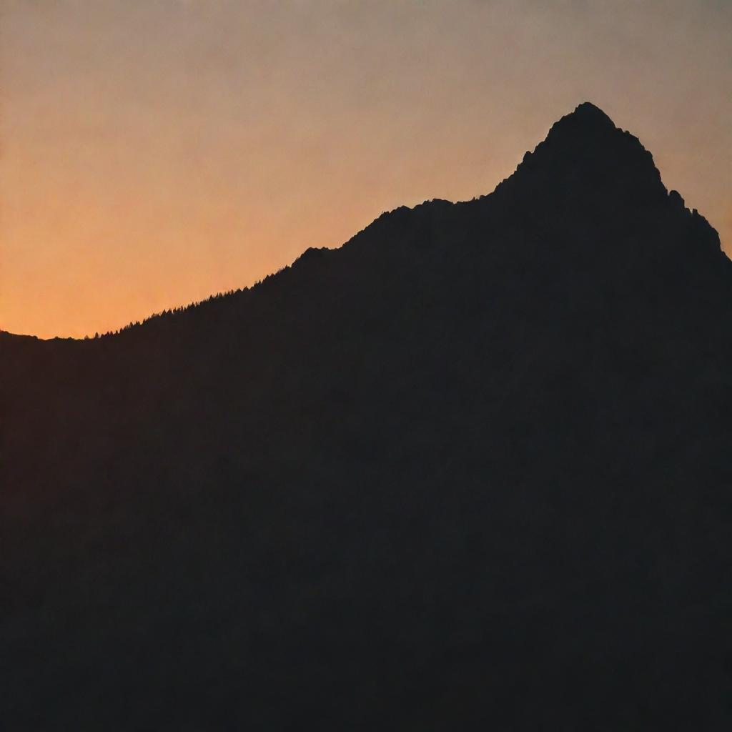 A silhouette of a mountain peak at sunset