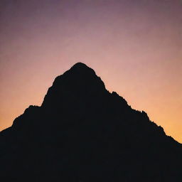 A silhouette of a mountain peak at sunset