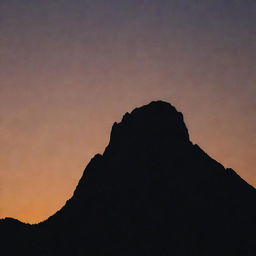 A silhouette of a mountain peak at sunset