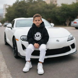 A boy in a black hoodie, white t-shirt, white pants, and white shoes, sitting on a Toyota Supra car. The car's license plate reads 'Zaibi'.