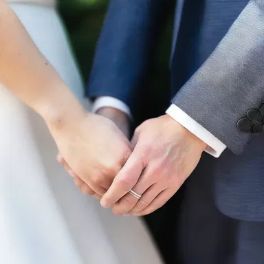 The couple held hands tightly, their fingers interlocking, symbolizing their unbreakable bond.