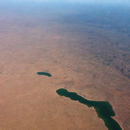 Aerial view of Algeria showcasing its diverse landscapes, from sandy Sahara desert, green Mediterranean coastline, to the snow-capped peaks of Atlas mountains.