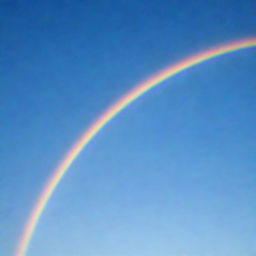 A vibrant, multi-colored rainbow arc stretching across a clear blue sky.