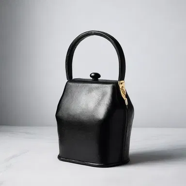 The fashion-forward designer created a unique coal scuttle purse, combining style and functionality.