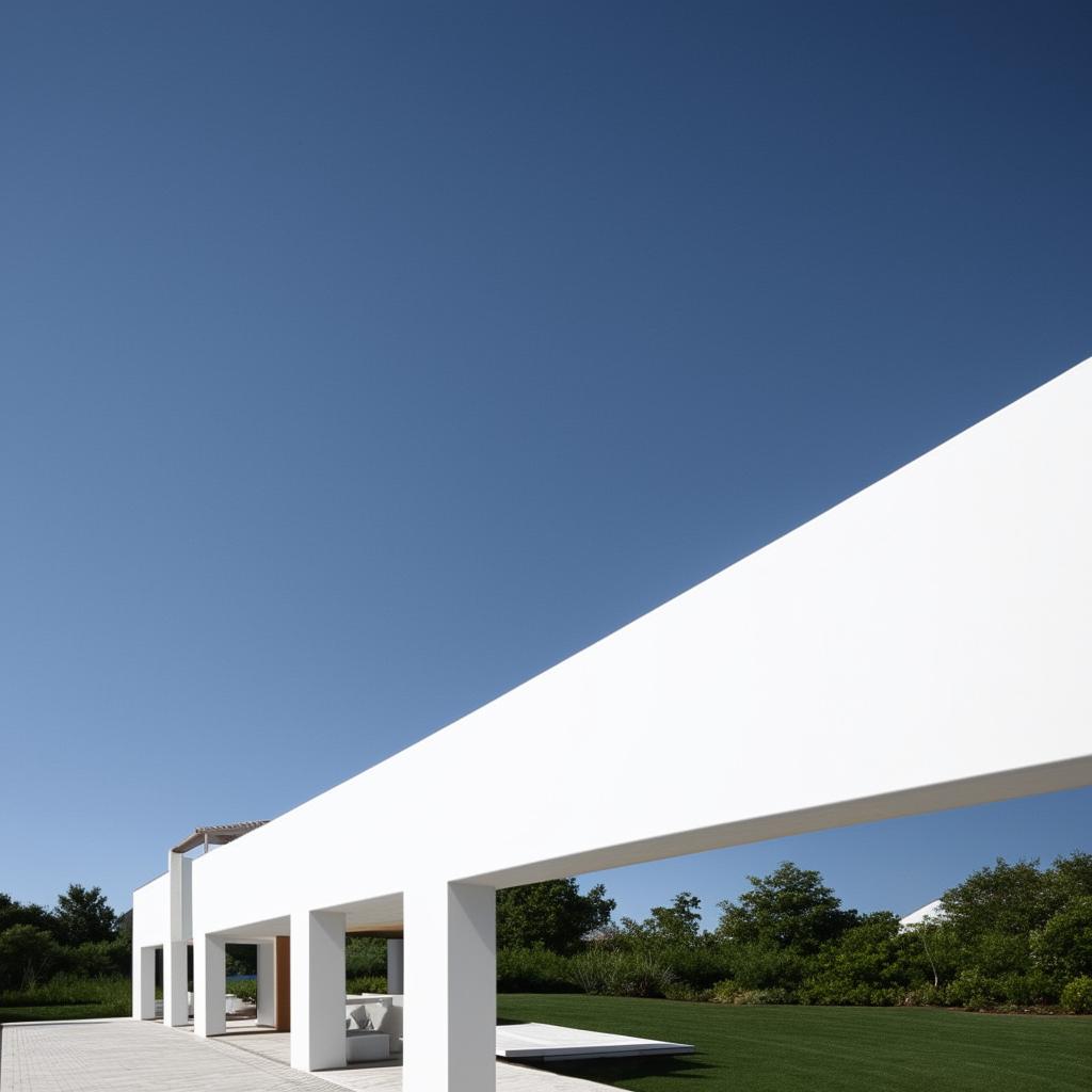 Architectural design of a T-shaped house, painted white, under clear blue skies