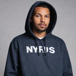 A man wearing a detailed hoodie with the name 'NYRUS' emblazoned across it