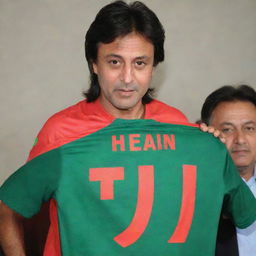 A PTI jersey T-shirt with the name 'SHEHZAD IQBAL' on it, and a picture of him standing beside Imran Khan