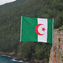 The Algerian flag depicted gracefully on a sea-facing wall, with a lush, green forest nearby. The flag's distinct green, white and red colours illuminate the natural scenery.