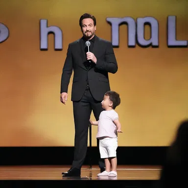 The comedian imitated a small child talking baby-like, making the audience burst into laughter.
