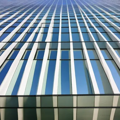 The building's glass facade has a refractive effect, causing the light to scatter and create beautiful patterns inside.