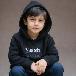 A boy sitting, wearing a black hoodie. The background features the name 'YASH'.