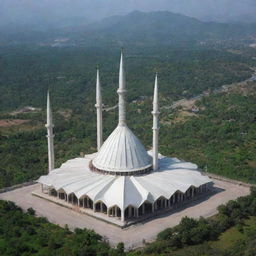 Beautiful view of Faisal Mosque in Islamabad, surrounded by lush green landscape under the clear blue sky.