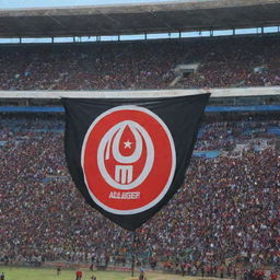 Logo of USM Alger, an Algerian football club, prominently displayed against a backdrop of their home stadium packed with enthusiastic fans, under a bright, clear blue sky.