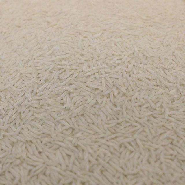 A large quantity of Basmati rice is displayed, highlighting the abundant amount of its long, slender, pearly white grains.