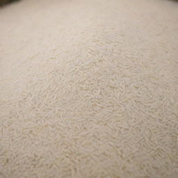 A large quantity of Basmati rice is displayed, highlighting the abundant amount of its long, slender, pearly white grains.