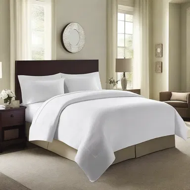 The upscale hotel advertises a luxurious white sale, offering discounted prices on premium quality bedding and towels.