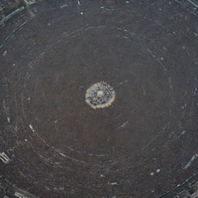 Aerial view of a massive gathering of 500,000 people, showcasing the scale and density of the crowd.