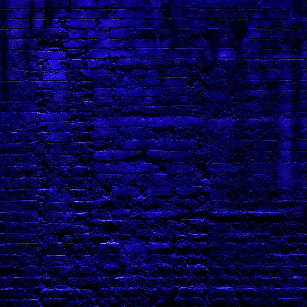 An abstract, dark image featuring a vintage partial brick wall with crumbling, broken, and cracked bricks in faded blue, yellow, and red hues, set against a moody, abstract background