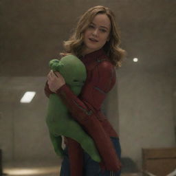 Brie Larson as Captain Marvel in a humorous scene, acting like a baby throwing a tantrum and being lifted by a strong, patient female alien.