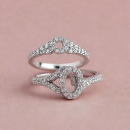 Two matching silver engagement rings encrusted with sparkling diamonds. One ring features an exquisite design of the letter 'J' and the other echoes this design but with the letter 'R'.