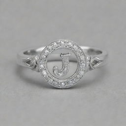 A silver ring adorned with a diamond, featuring the letter J etched into it. Another identical ring features the letter R instead.