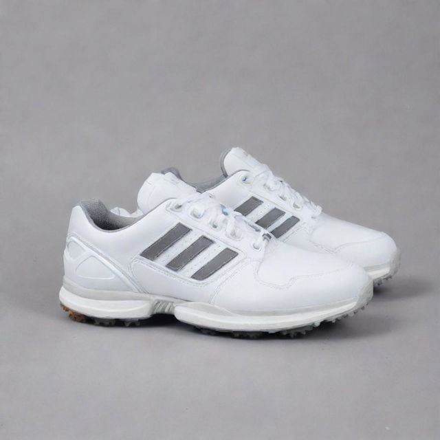 A pair of ZX 8000 Golf shoes in pristine condition. They are well-crafted with meticulous details, showcasing a blend of modern style and functionality.