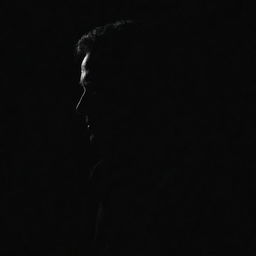 Create a stark image of a mysterious silhouette of a man set against a dark, black background