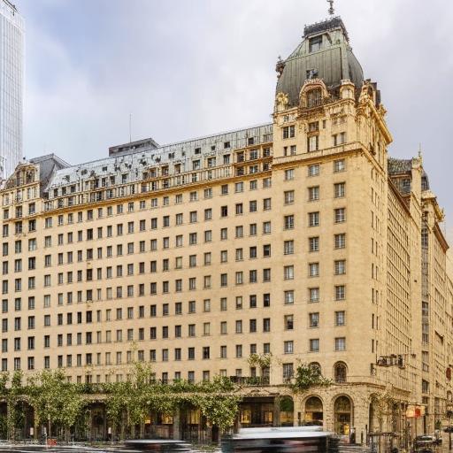 A grand hotel with a towering facade, multiple windows, and elegant architectural design.