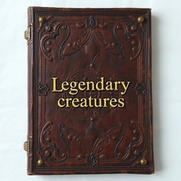 An old A4-sized leather brown book cover with a gold shining 'Legendary creatures' sentence in the middle