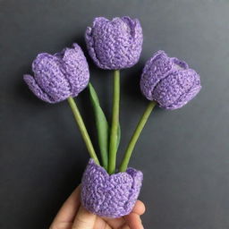 Three crochet tulips in pastel purple color, intricately wrapped in a dark purple wrapper.