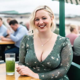 A curvy blond woman with hair in a sexy plait is seated in a cafe overlooking the beach at Lyme Regis