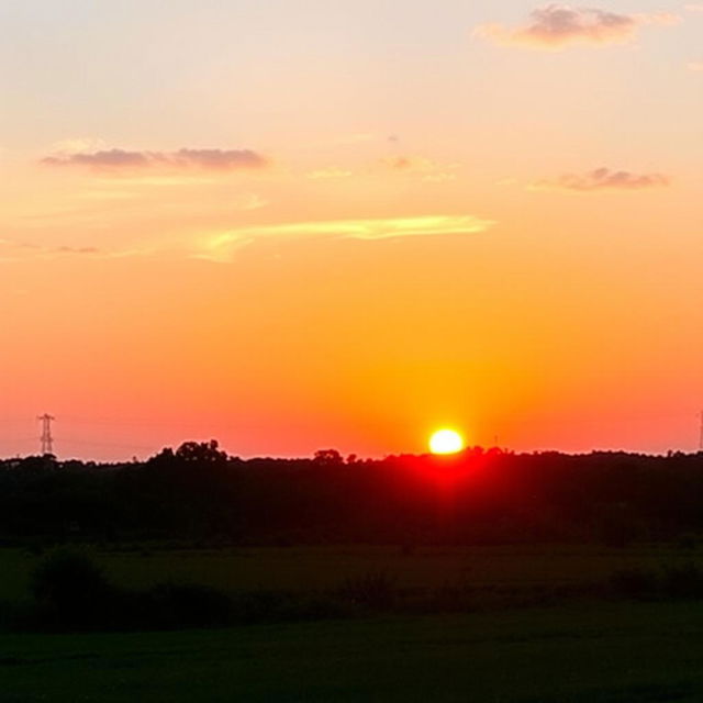 A beautiful sunset scene with the sun low on the horizon, casting a warm golden glow over a serene landscape