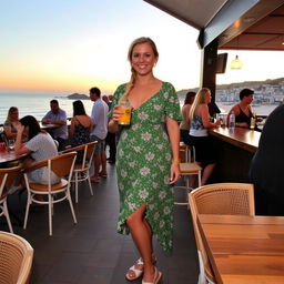 A curvy blond woman with hair in a plait, standing in a cafe overlooking the beach at St Ives