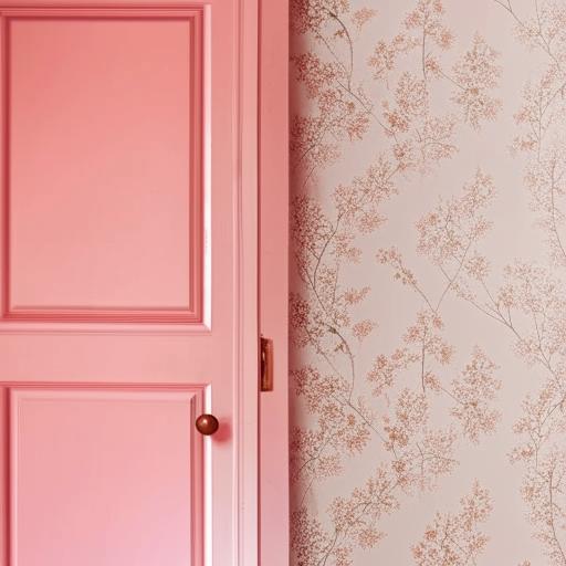 A room with one wall covered in vibrant floral wallpaper, and the remaining walls painted in a soft dusty pink