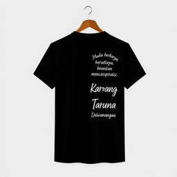 Black T-shirt with a small, modern logo on the front left (left chest) and the back featuring aesthetic, contemporary text "Muda berkarya, berani dan menginspirasi" and "Karang Taruna Putra Dewangga" in a stylish and trendy font