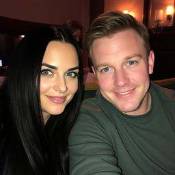 A couple sitting together, the woman has long black hair and striking blue eyes, while the man has expressive blue eyes and short brown hair