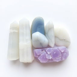 A beautiful array of selenite, blue lace agate, howlite, and lepidolite crystals displayed on a white background