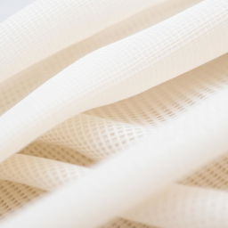 A close-up of fine textiles, showcasing intricate weaving techniques and subtle color variations