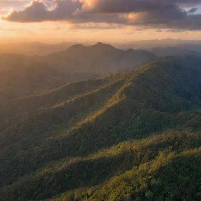 Panoramic view of a dense Melanesian mountain forest range, bathed in the vibrant hues of a setting sun sinking behind the mountains.