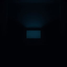 A dimly lit room with a single computer casting a soft glow