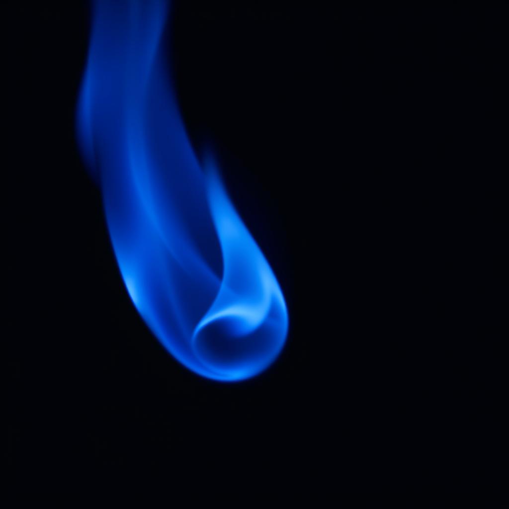 A serene blue flame gently floating above a dark background, emitting a soft glow