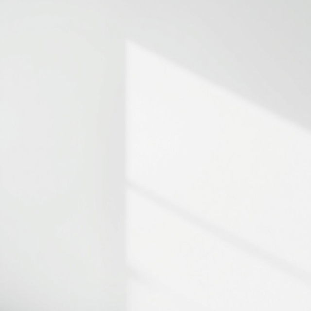 A plain white wall with a smooth surface, capturing the essence of simplicity and purity