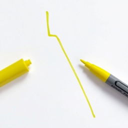 Draw a bright yellow lightning bolt with a marker on a sheet of paper