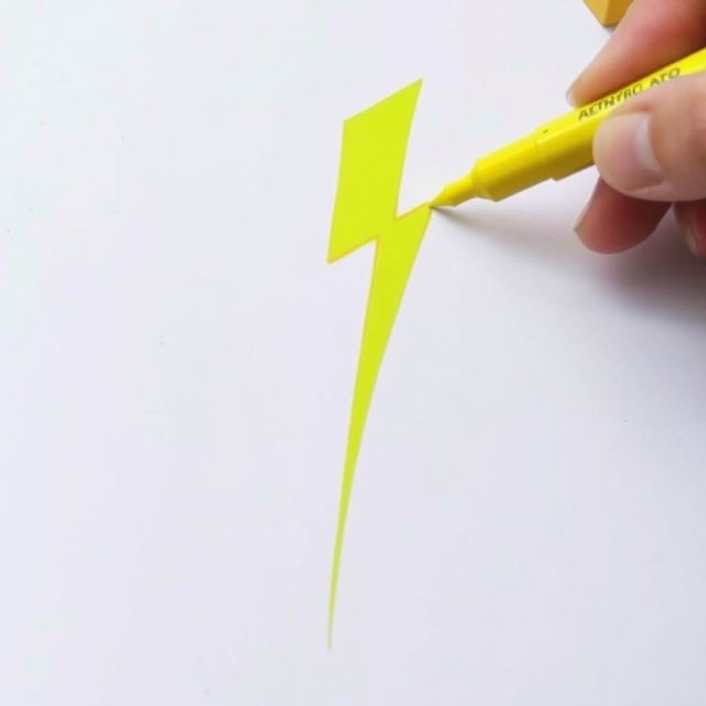 Draw a bright yellow lightning bolt with a marker on a sheet of paper