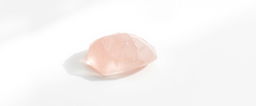 A single piece of rose quartz crystal displayed on a stark white background