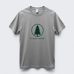 A plain grey t-shirt with a pine tree logo and the text 'fb dusun semilir' on the front, displayed against a neutral background